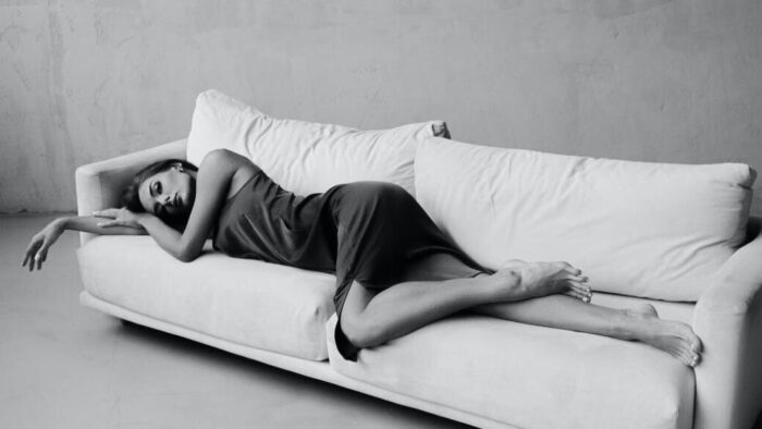 woman in dress sleeping on sofa