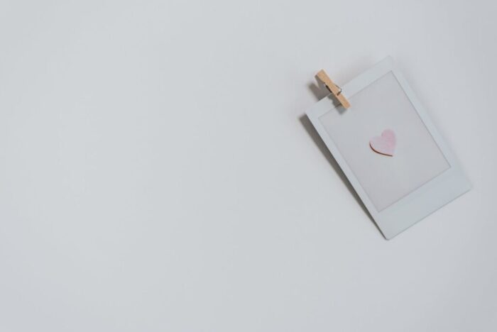 instant photo with small heart on white surface