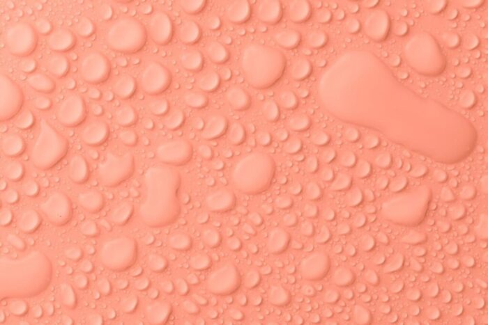 peach colored background with water drops